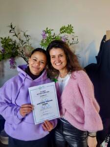 Anethea holding her certificate together with agency owner Emeline Van der Vecht