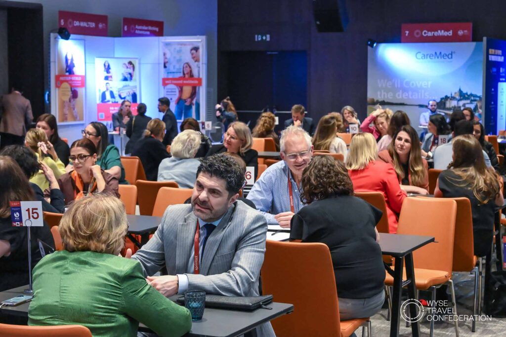 business meetings during WTM-IAC: Pople talking to each other sitting at several tables in one on one meetings